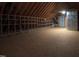 Large finished attic with wood beams, shelving, and plenty of potential storage space at 2109 Taramar Ln, Zebulon, NC 27597