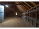 Finished attic space with wood beams, ample storage shelves, and a window for natural light at 2109 Taramar Ln, Zebulon, NC 27597