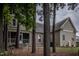 Well-maintained backyard featuring a screened porch, trees, and a manicured lawn area at 2109 Taramar Ln, Zebulon, NC 27597