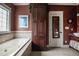 Bathroom features a tub, vanity, and a large storage cabinet at 2109 Taramar Ln, Zebulon, NC 27597