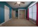 A bright bedroom with blue walls, plush carpet, and a walk-in closet offers a cozy and functional living space at 2109 Taramar Ln, Zebulon, NC 27597