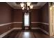 A dining room featuring a window with elegant curtains and hardwood floors exudes a refined and comfortable ambiance at 2109 Taramar Ln, Zebulon, NC 27597