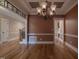 A dining room with hardwood floors, a decorative chandelier, and classic wainscoting provides a welcoming space for gatherings at 2109 Taramar Ln, Zebulon, NC 27597