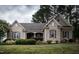 Charming brick home with manicured lawn, shrubbery, and a welcoming walkway at 2109 Taramar Ln, Zebulon, NC 27597
