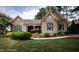 Charming brick home with manicured lawn, shrubbery, and a welcoming walkway at 2109 Taramar Ln, Zebulon, NC 27597