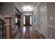 Grand foyer features hardwood floors, staircase with iron railings, and natural light at 2109 Taramar Ln, Zebulon, NC 27597