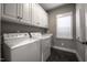 Laundry room with washer, dryer, white cabinets, and a sink at 2109 Taramar Ln, Zebulon, NC 27597