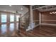 Spacious living room with hardwood floors, staircase with iron railings, and lots of natural light at 2109 Taramar Ln, Zebulon, NC 27597