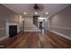 Spacious living room with hardwood floors, fireplace, staircase with iron railings, and natural light at 2109 Taramar Ln, Zebulon, NC 27597