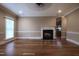 Open concept living room with hardwood floors, fireplace, and view into the kitchen at 2109 Taramar Ln, Zebulon, NC 27597