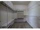 Empty walk-in closet with multiple shelves and hanging racks at 2109 Taramar Ln, Zebulon, NC 27597