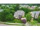Aerial view of a brick two story home surrounded by mature trees and lush green lawns at 220 Cole Valley Dr, Cary, NC 27513