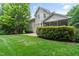 Expansive backyard with healthy green grass, trees and patio, showcasing the property's outdoor living space at 220 Cole Valley Dr, Cary, NC 27513