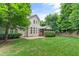 Well-maintained backyard featuring a lush lawn, mature trees, and a patio area, ideal for outdoor enjoyment at 220 Cole Valley Dr, Cary, NC 27513
