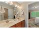 Bathroom featuring a double sink vanity with a light wood cabinet, and a large mirror at 220 Cole Valley Dr, Cary, NC 27513