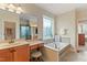 Bathroom with a soaking tub, makeup vanity, and a frameless glass shower at 220 Cole Valley Dr, Cary, NC 27513