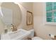 Half bathroom with vanity, gold fixtures, round mirror, and natural light at 220 Cole Valley Dr, Cary, NC 27513