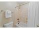 Standard bathroom showcasing a bathtub with a white curtain, a toilet, and a towel rack at 220 Cole Valley Dr, Cary, NC 27513