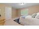 Neutral bedroom featuring a window and a door at 220 Cole Valley Dr, Cary, NC 27513