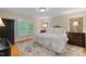 Bright bedroom features a large window, hardwood floors, and a stylish black armoire at 220 Cole Valley Dr, Cary, NC 27513