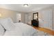 Bright bedroom features hardwood floors and neutral walls, creating a cozy and inviting atmosphere at 220 Cole Valley Dr, Cary, NC 27513