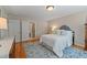 View of bedroom showcasing a bed, dresser, and an area rug over hardwood flooring at 220 Cole Valley Dr, Cary, NC 27513