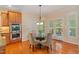 Cozy breakfast nook with glass table and exterior doors to backyard at 220 Cole Valley Dr, Cary, NC 27513
