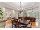 Elegant dining room with hardwood floors, chandelier, and access to other living spaces at 220 Cole Valley Dr, Cary, NC 27513