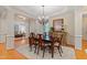 Formal dining room featuring hardwood floors, a chandelier, and a large wooden dining table at 220 Cole Valley Dr, Cary, NC 27513