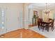 Elegant dining room with hardwood floors, chandelier, and a classic wooden table set for six at 220 Cole Valley Dr, Cary, NC 27513