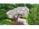 Beautiful two-story brick home with mature trees, lush landscaping, and a welcoming front porch at 220 Cole Valley Dr, Cary, NC 27513