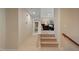 Neutral hallway leading to a cozy living room and bedroom, offering seamless connectivity at 220 Cole Valley Dr, Cary, NC 27513