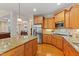 Open kitchen with granite countertops, stainless steel appliances, and hardwood floors at 220 Cole Valley Dr, Cary, NC 27513