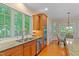 Well-lit kitchen featuring stainless steel appliances, hardwood floors, and a double sink at 220 Cole Valley Dr, Cary, NC 27513