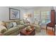 Cozy living room with comfortable sofa, armchair, decorative pillows, and natural light from the window at 220 Cole Valley Dr, Cary, NC 27513