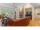 Cozy living room featuring a stone fireplace, hardwood floors, and large windows at 220 Cole Valley Dr, Cary, NC 27513