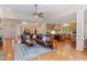 Open-concept living room with a leather sofa, hardwood floors, and adjacent kitchen at 220 Cole Valley Dr, Cary, NC 27513