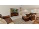 Cozy living room featuring leather furniture, a large television, and a comfortable ottoman at 220 Cole Valley Dr, Cary, NC 27513