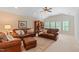 Spacious living room with vaulted ceilings, leather furniture, and a ceiling fan for comfort at 220 Cole Valley Dr, Cary, NC 27513