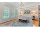 Main bedroom with a decorative rug, white bedding, and lots of natural light at 220 Cole Valley Dr, Cary, NC 27513
