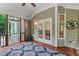 Charming screened porch with wood flooring and white french doors, perfect for relaxing and enjoying the outdoors at 220 Cole Valley Dr, Cary, NC 27513
