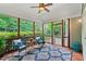 Inviting screened porch with stylish seating, a ceiling fan, and views of the lush, green surroundings at 220 Cole Valley Dr, Cary, NC 27513