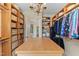 Spacious walk-in closet featuring a central island and custom built-in wooden shelving at 220 Cole Valley Dr, Cary, NC 27513