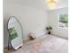 Modern bedroom features plush carpet, large windows, and decorative mirror at 2201 Alpine Rd, Durham, NC 27707