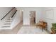 Entryway features natural light, stairs with black accents, and doorway to kitchen at 2201 Alpine Rd, Durham, NC 27707