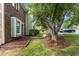 Landscaped front yard featuring healthy green grass and meticulously arranged mulch beds add curb appeal to this home at 2201 Alpine Rd, Durham, NC 27707