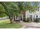 Charming townhome featuring a mix of brick and siding, complemented by lush landscaping and a welcoming entrance at 2201 Alpine Rd, Durham, NC 27707