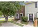 Charming townhome featuring a mix of brick and siding, complemented by lush landscaping and a welcoming entrance at 2201 Alpine Rd, Durham, NC 27707