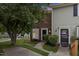 Charming townhome featuring a mix of brick and siding, complemented by lush landscaping and a welcoming entrance at 2201 Alpine Rd, Durham, NC 27707