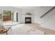Living room with a fireplace, sliding glass door leading to the backyard, and stairway access at 2201 Alpine Rd, Durham, NC 27707